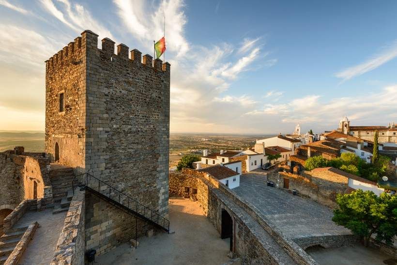 A hilltop Alentejo village, its castle keep above the plain at golden hour